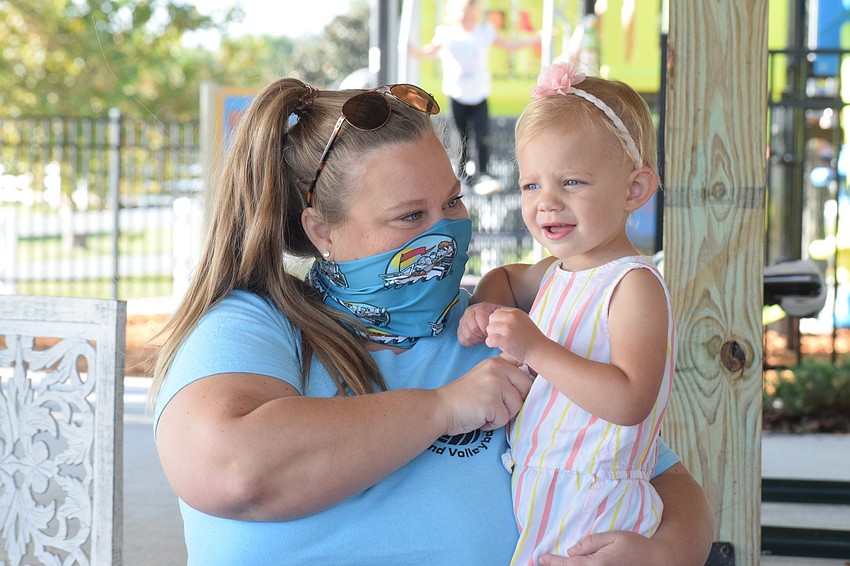 Harmony's Jessi McComas sings and tickles her 1-year-old daughter Josie McComas during the second song of the class.
