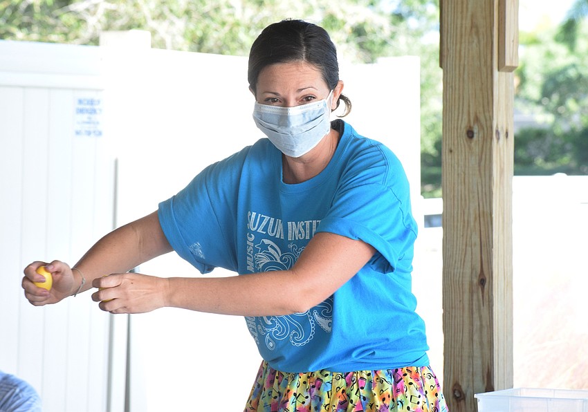 Amy Lemon, instructor of the Mommy and Me Music Class, pretends to stir using her egg rattles.