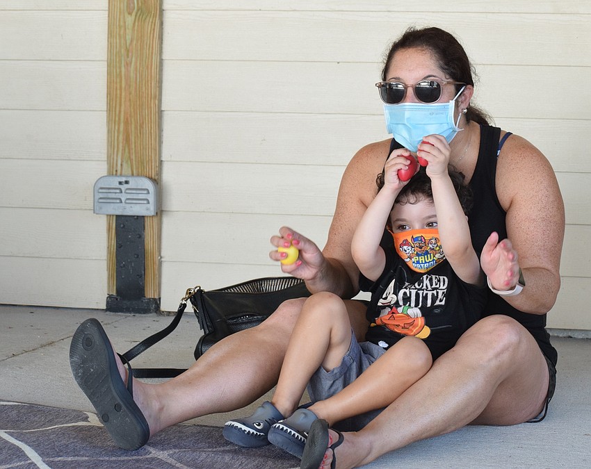 Lakewood Ranch's Randee Bunin and her 3-year-old son Jacob Bunin have fun while singing and using egg rattles.