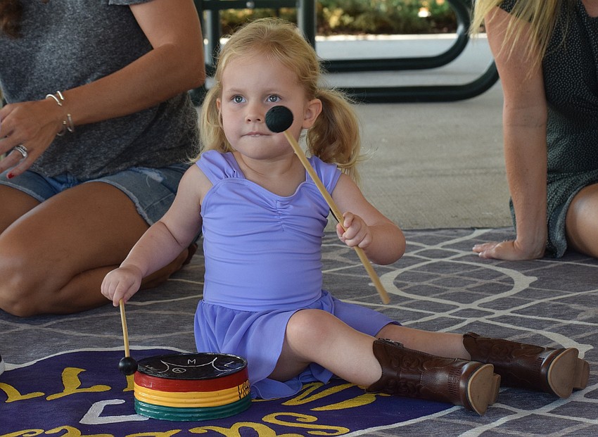 Sarasota's Nora LaDow makes her own music with a drum during free play.