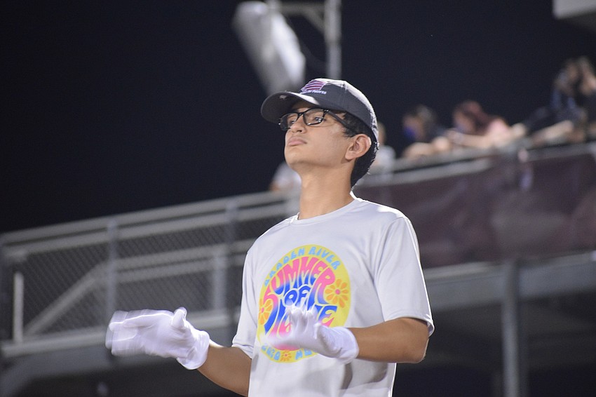 Jordan Sheehan, a senior and drum major, conducts.