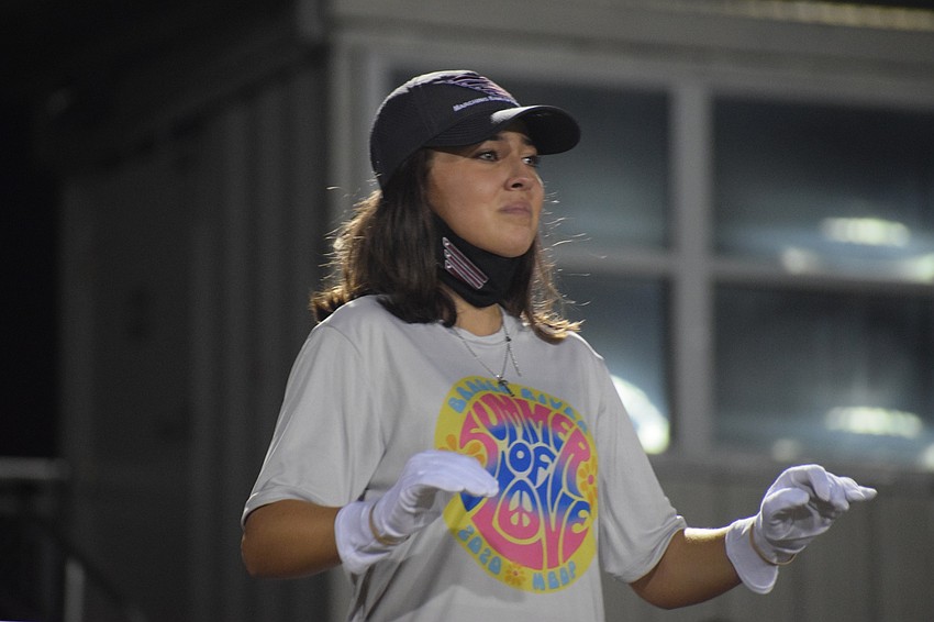 Allison Guzman, a senior and drum major, gets emotional during her last performance with the Marching Band of Pirates. This is Guzman's second year being a drum major.