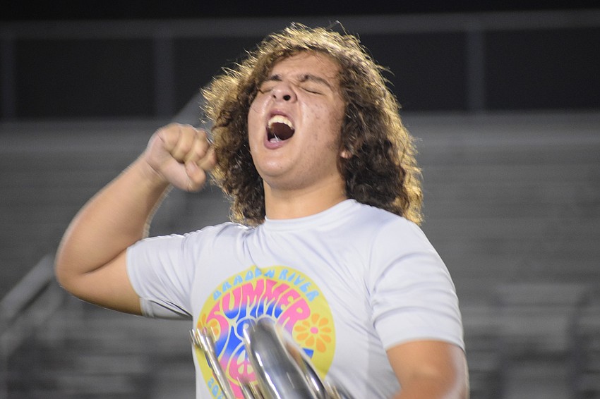 Jonah Jacobbi cheers for Braden River High School during the school's fight song.