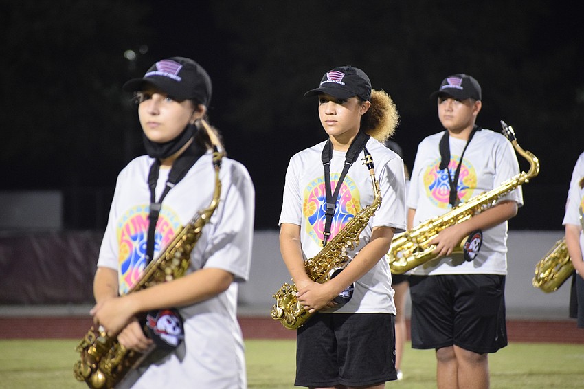 Makayla Moclado, Adanna Wharton and Ian Gonzalez wait at attention for the performance to start.