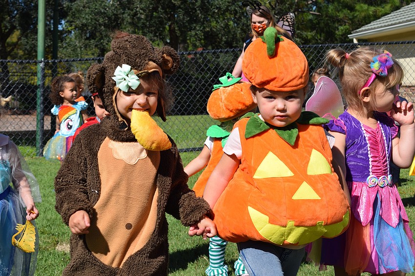 Kira Miller dresses as a monkey and holds hands with Alice McCarthy during their Parade of Costumes at Primrose School at Lakewood Ranch Town Center.