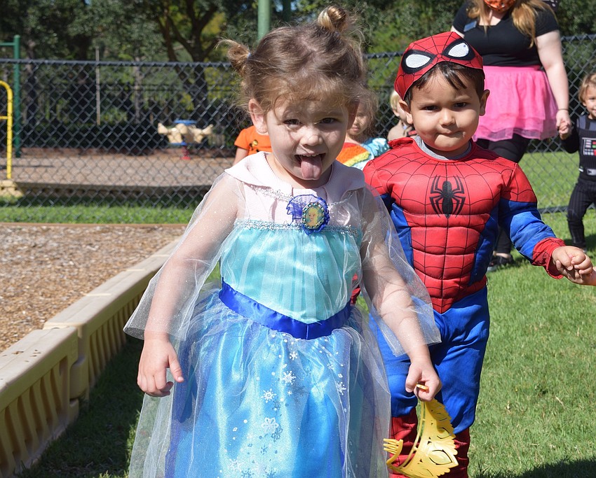 Amelia Chiaro makes a face while Joaquin Vicente follows behind in the Parade of Costumes at Primrose School at Lakewood Ranch Town Center.