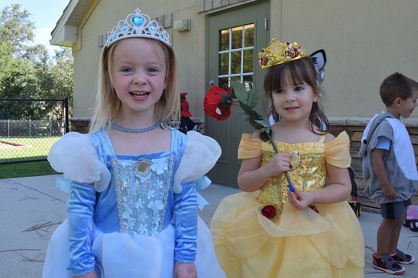Phoebe Horbath and Ava Marasco act like princesses in their Cinderella and Belle costumes.