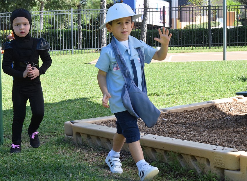 Jayce Kozel walks with Leo Elmasri during the parade.