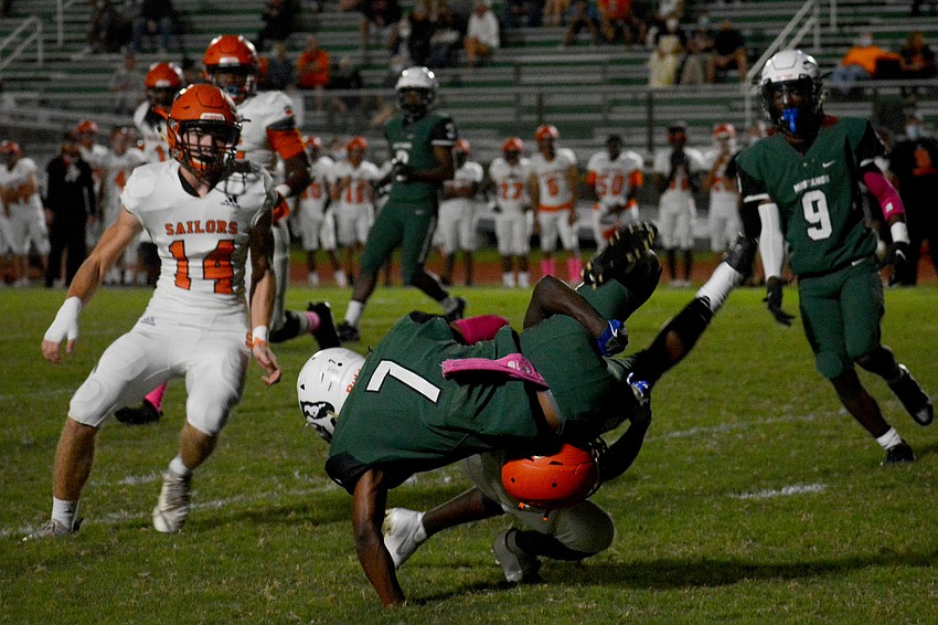 Mustangs running back Eli Daniels (7) gets upended by a Sailors defender.