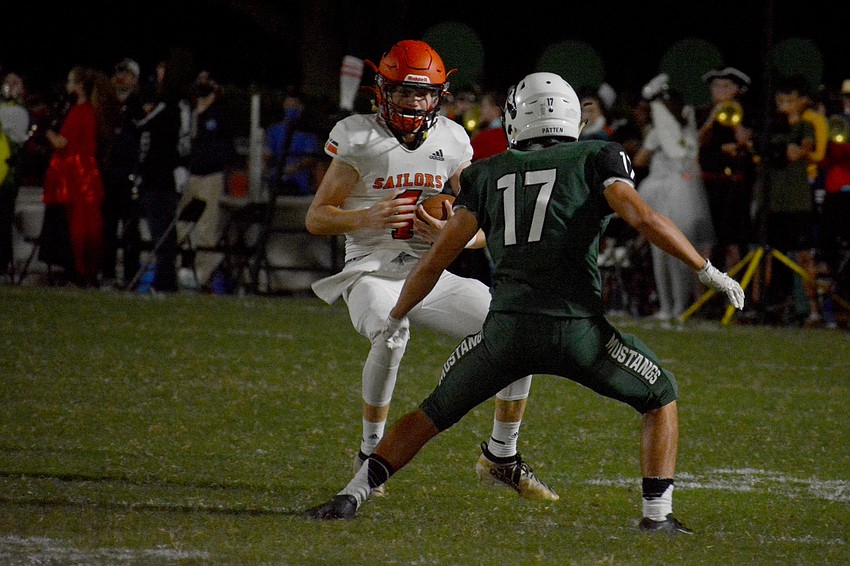 Sailors quarterback Lance Trippel  (4) stares down Mustangs defensive back Travis Patten (17).