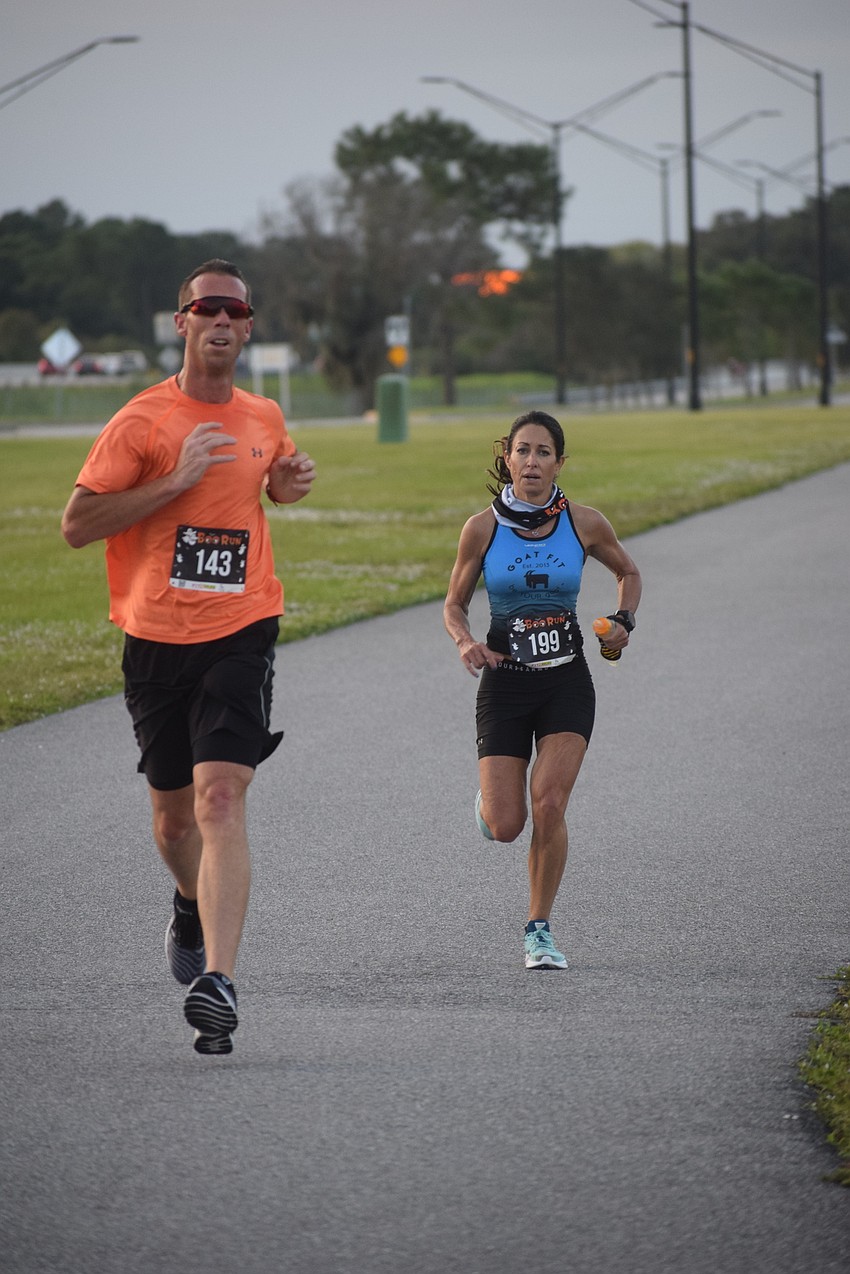 Parrish's Matthew Laliberte and Dunedin's Janae Pranschke head for the finish line of the Boo Run.