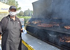 Perry Washington tends to his Perry's Original Roadside and Barbecue offerings. The wonderful smells wafted throughout the Market at Lakewood Ranch.