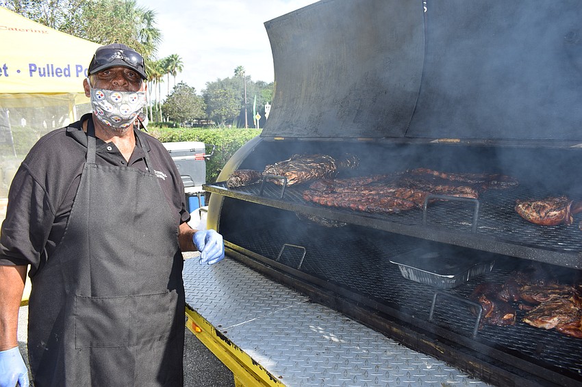 Perry Washington tends to his Perry's Original Roadside and Barbecue offerings. The wonderful smells wafted throughout the Market at Lakewood Ranch.