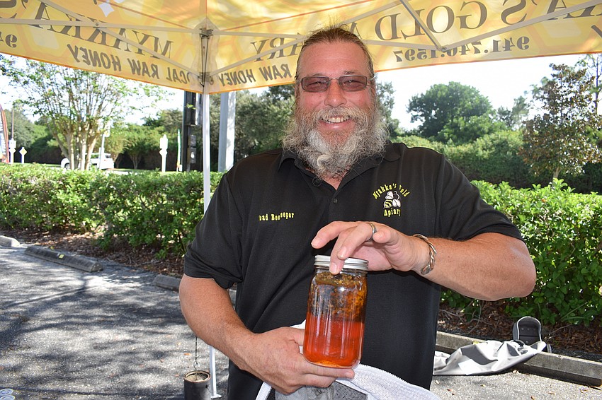 James Cutway's booth, Myakka's Gold Apiary, was a hit as always. Note that everyone in this photo gallery was wearing a mask but pulled it down for the photo.