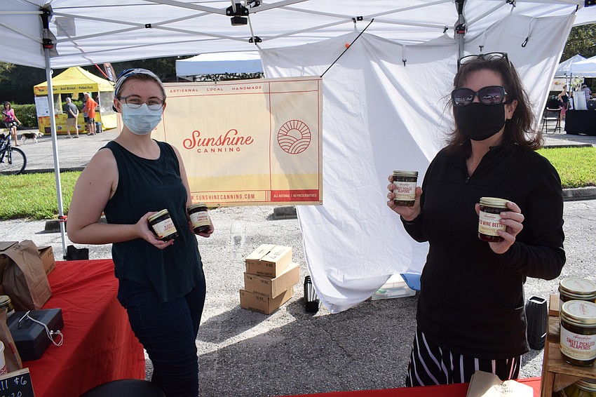 Bradenton's McKenzie Cameron and Sunshine Canning owner Lisa Fulk show off some of their popular items.