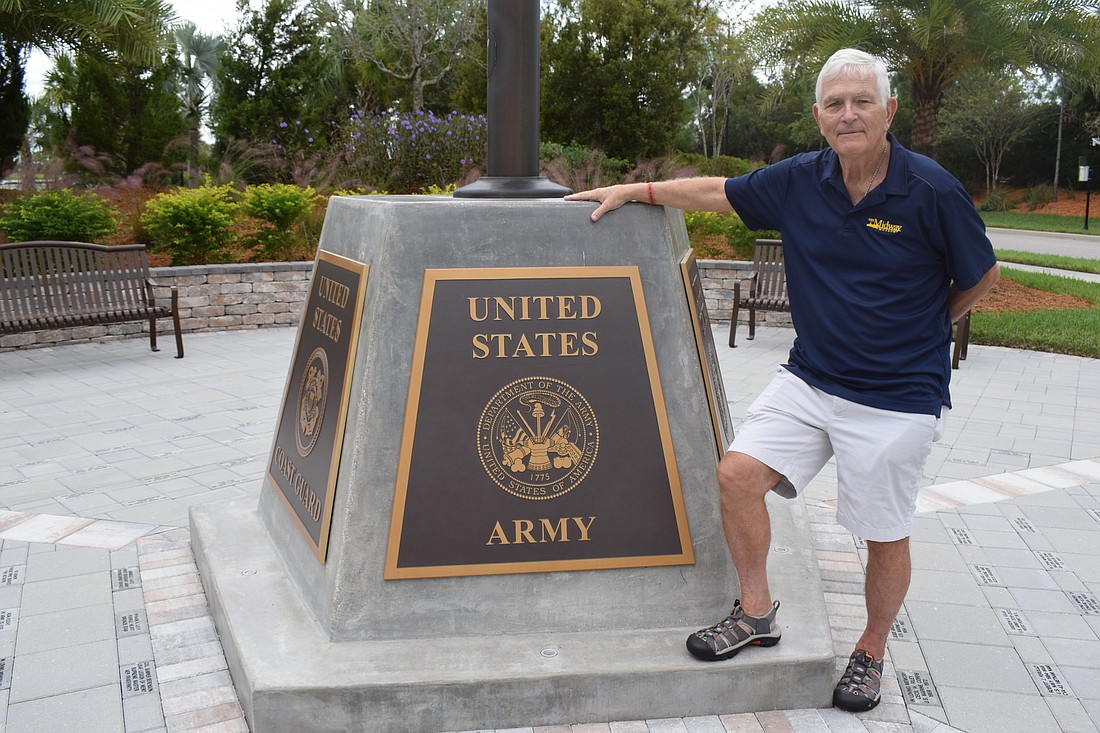 Del Webb&#39;s Dr. Richard Hurd stands alongside  the Circle of Honor Memorial at Del Webb dedicated to the armed forces.