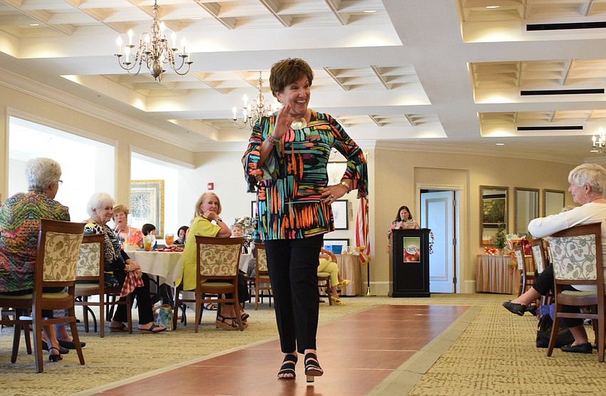 Joyce Giaconia struts down the runway giving people a wave as she goes by.