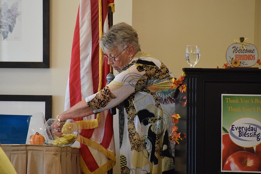 Joyce Yancey, one of the organizers of the fashion show, pulls out a raffle ticket to give away prizes.