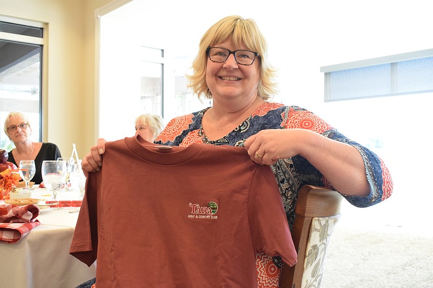 Kim Randolph shows off the Tara Golf and Country Club shirt she won as a prize.