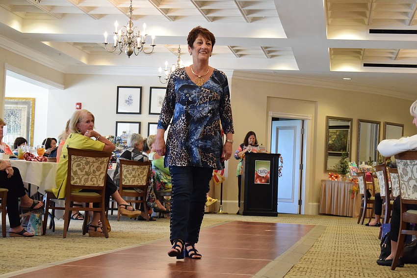 MaryAnn McWilliams makes her way down the runway wearing a top that combines denim with animal print.