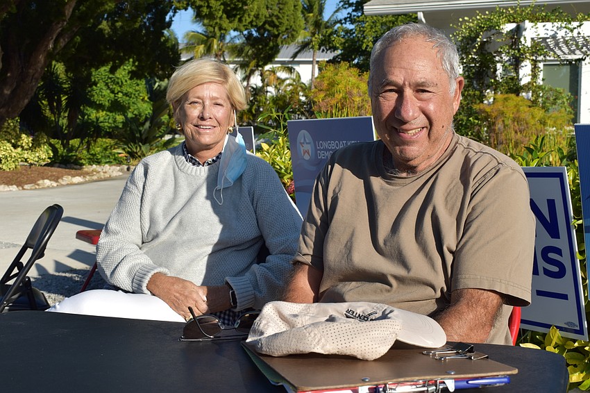 Perry Guzman and Howard Cohen of the Longboat Key Democratic Club pose for a picture on Tuesday at the Longboat Island Chapel.