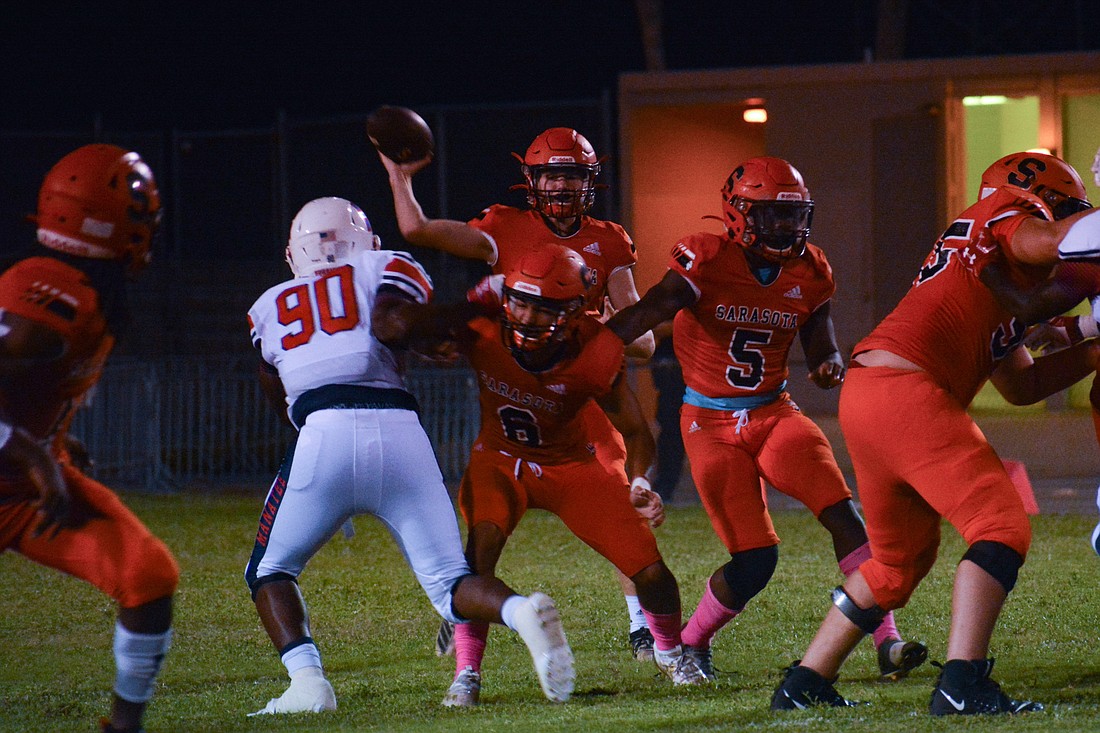 Lance Trippel throws a pass over the middle against Manatee High.