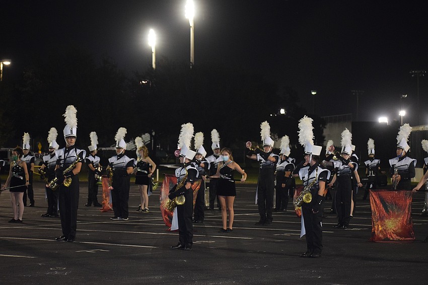 The Lakewood Ranch High School Marching Mustangs take to the practice field for a final performance in their uniforms.