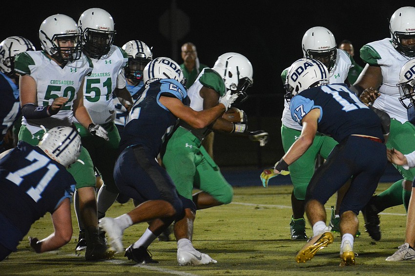 Nolan Lewellen (22) makes a tackle on a Ocala running back.