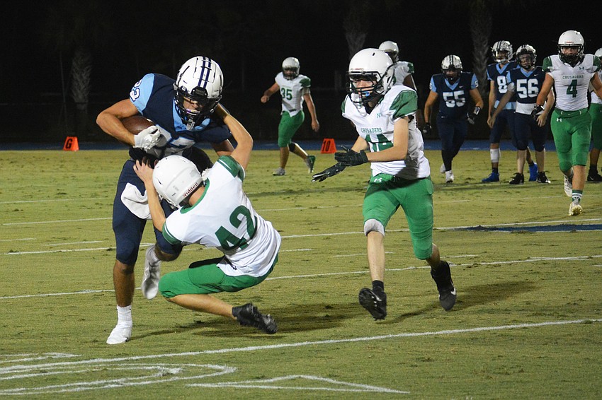 Nolan Lewellen runs over Ocala's Daniel Young.
