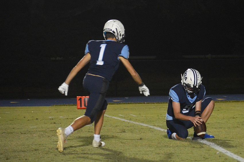 Jackson Carlton (1) hits an extra point.