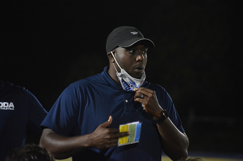 KB Belton talks to him team after his first win as a head coach.