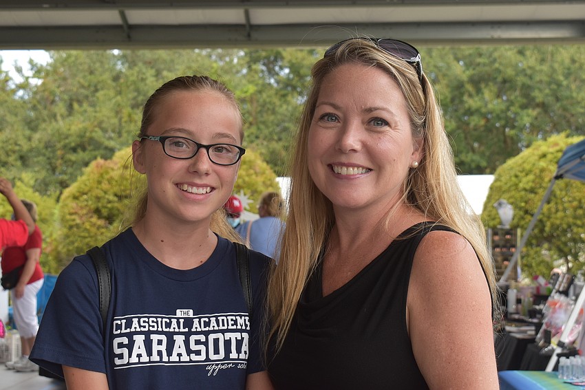 Madelynn McAfee (left) and her mother, Victoria McAfee, of Parrish came to the craft show to get in the Christmas spirit. Victoria said the wreaths caught her eye and all the vendors were very friendly.