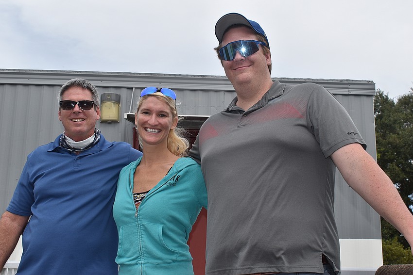 (From left) Jeff Mohler, Kim Bolyard and her husband, Seth Bolyard, all of Palmetto, came to the craft show to do Christmas shopping. Mohler is the father of Night with the Stars board member Nicole Washington.