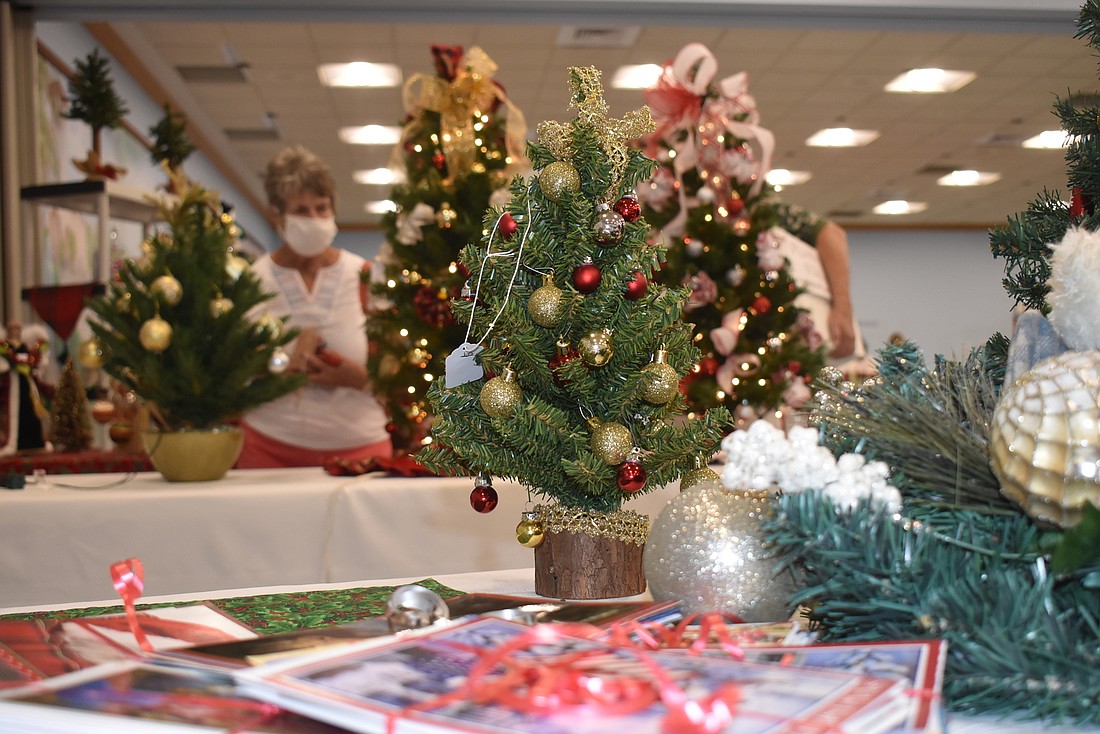 Midge Pescatello browses among the hand-decorated trees at St. Mary, Star of the Sea's 2020 Christmas Bazaar.