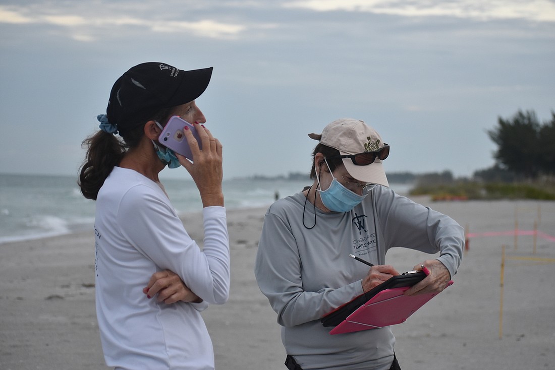 Cyndi Seamon and Ann Tannen wear PPE when recording nests near each other in July 2020.