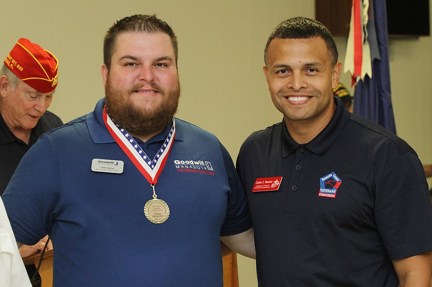 Todd Hughes accepted his Veteran of the Year award and posed with Carlos Moreira, president of the Sarasota County Veteran's Commission.