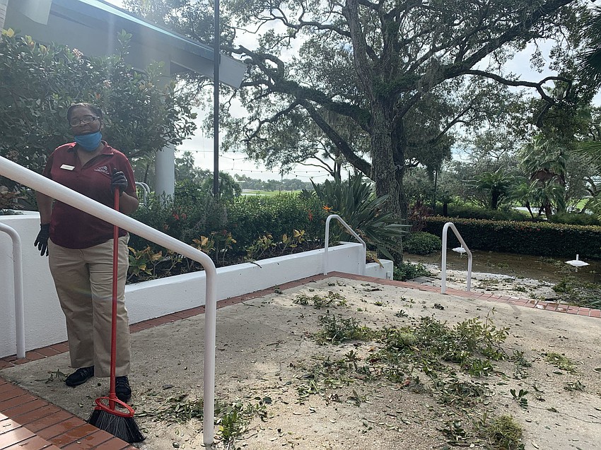Rosemarie Cidera sweeps up at Whisky Tavern. (Nat Kaemmerer)