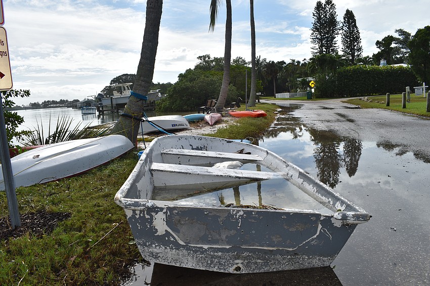 A boat is filled with water on Lois Avenue in the Longbeach Village neighborhood.