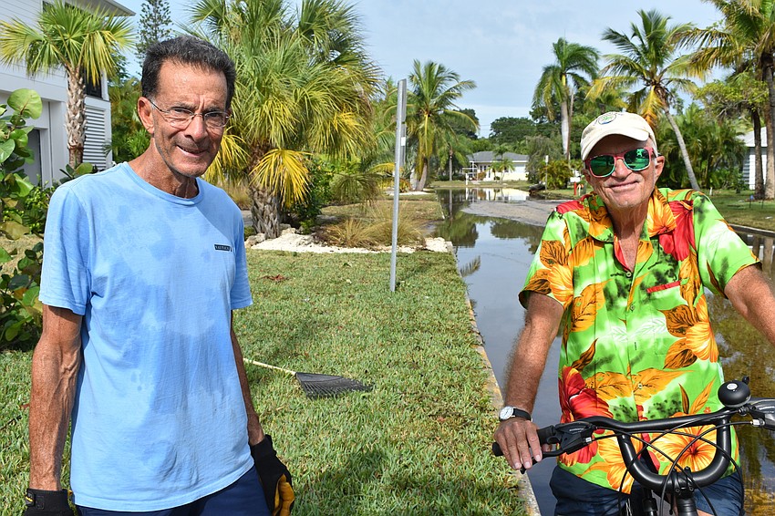 John DeVito (left) and Fred Kagi (right) chat Thursday morning after Eta passed through the day before.
