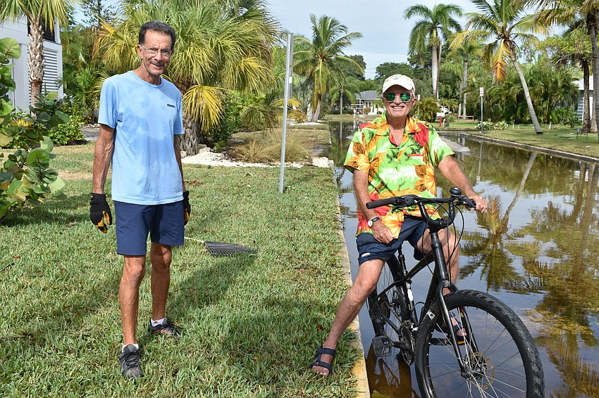 John DeVito (left) and Fred Kagi (right) chat Thursday morning after Eta passed through the day before.