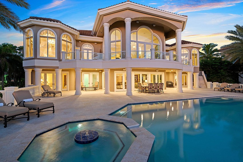 A pool and spa overlook the beach.
