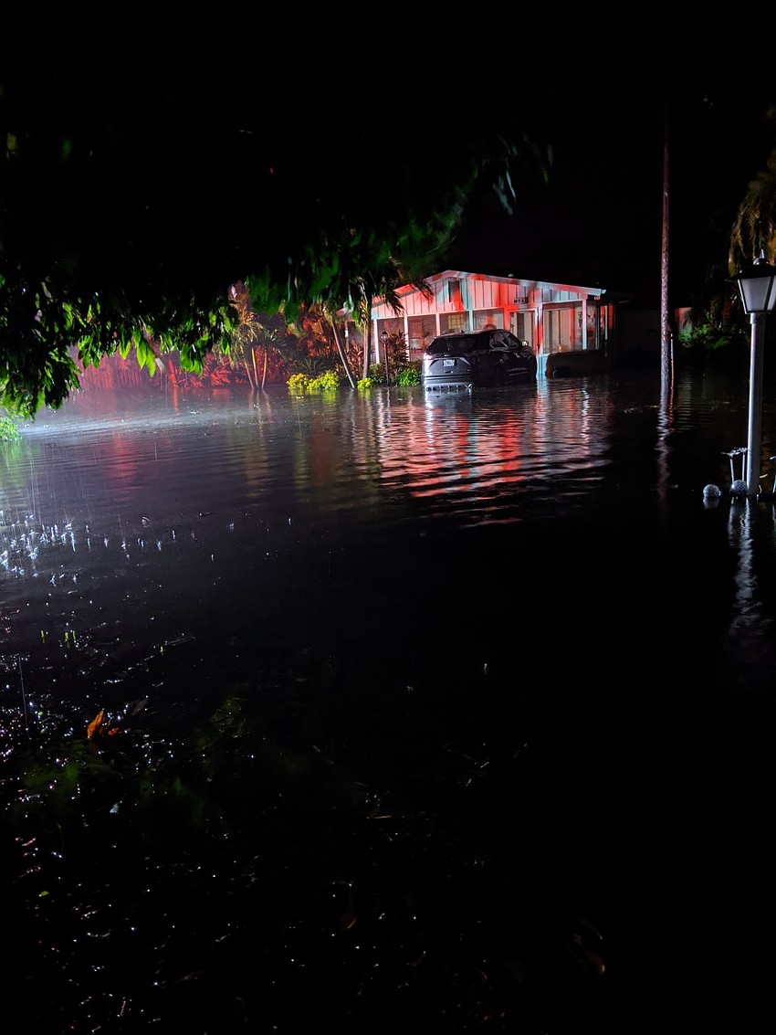 Lights from a fire truck reflect off the water in the street. Braha's next-door neighbors called after smelling electrical smoke from their washing machine. (Courtesy of Vashti Braha)