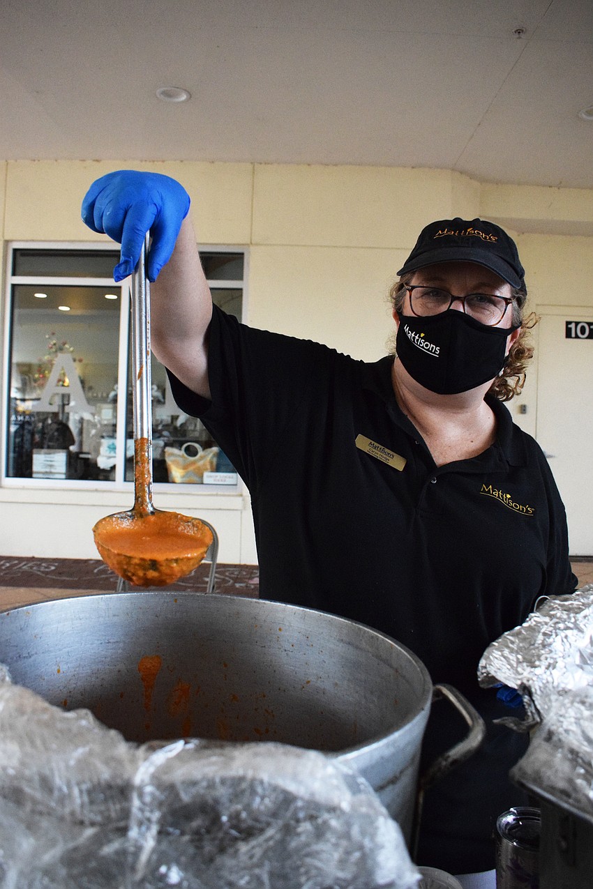 Caryn Hodge, the marketing director for Mattison's, pours some tomato gorgonzola bisque into a to-go cup.