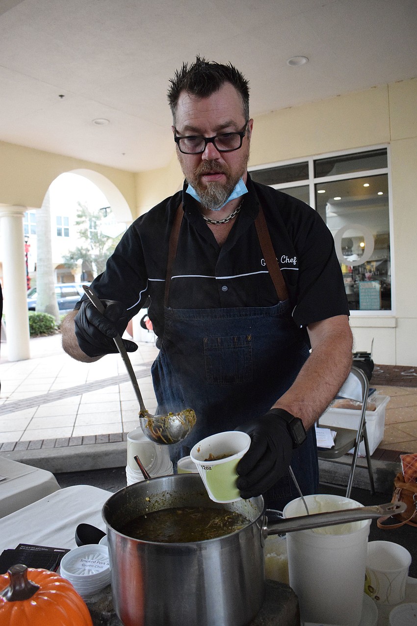 Evan Percoco with Atypical Kitchen makes a serving of soup that has smoke pork and green chili with kotija, sour cream and cilantro.