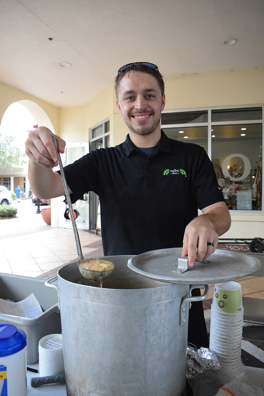 Justin Gorrell, a managing partner with Metro Diner, serves roasted corn and shrimp chowder.