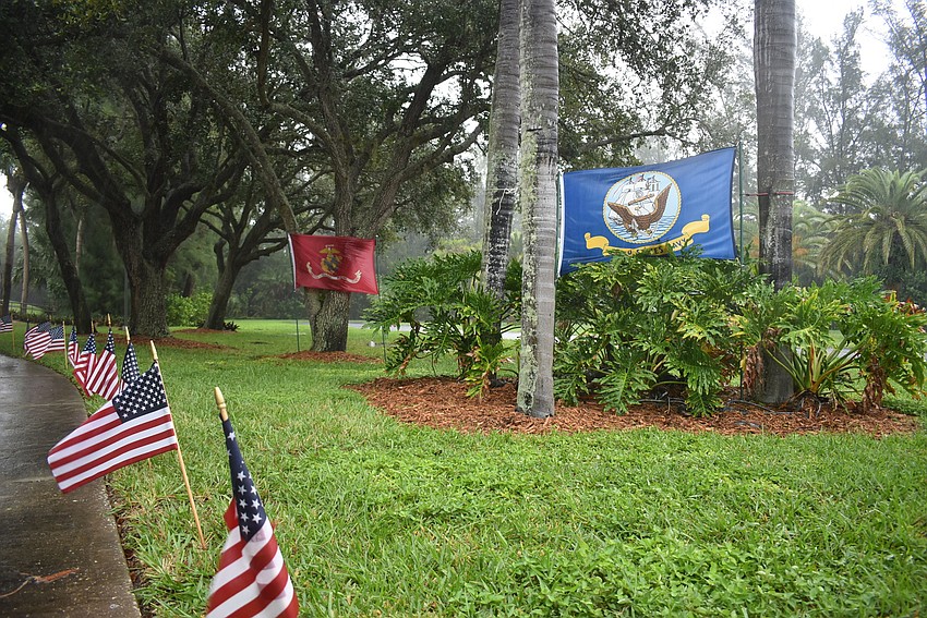 Small American flags lined Bay Isles Road leading to the circle drive, where Rotary volunteers were waiting to celebrate veterans who drove by.