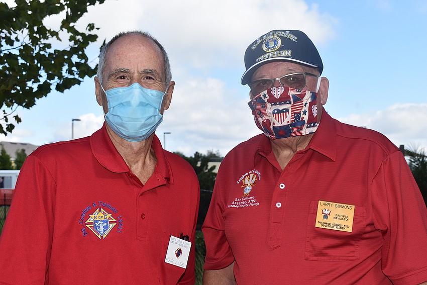 Knights of Columbus member Richard Kuebel (left) and four-year Air Force veteran Larry Simmons said they were smiling under their masks.