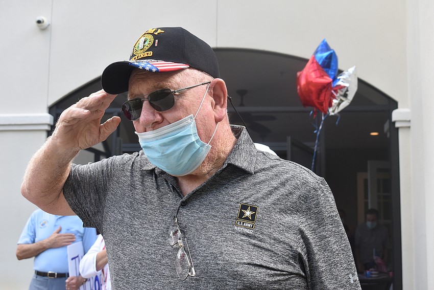 41-year Army veteran Rich Macklin stands at attention for the playing of the Star-Spangled Banner.