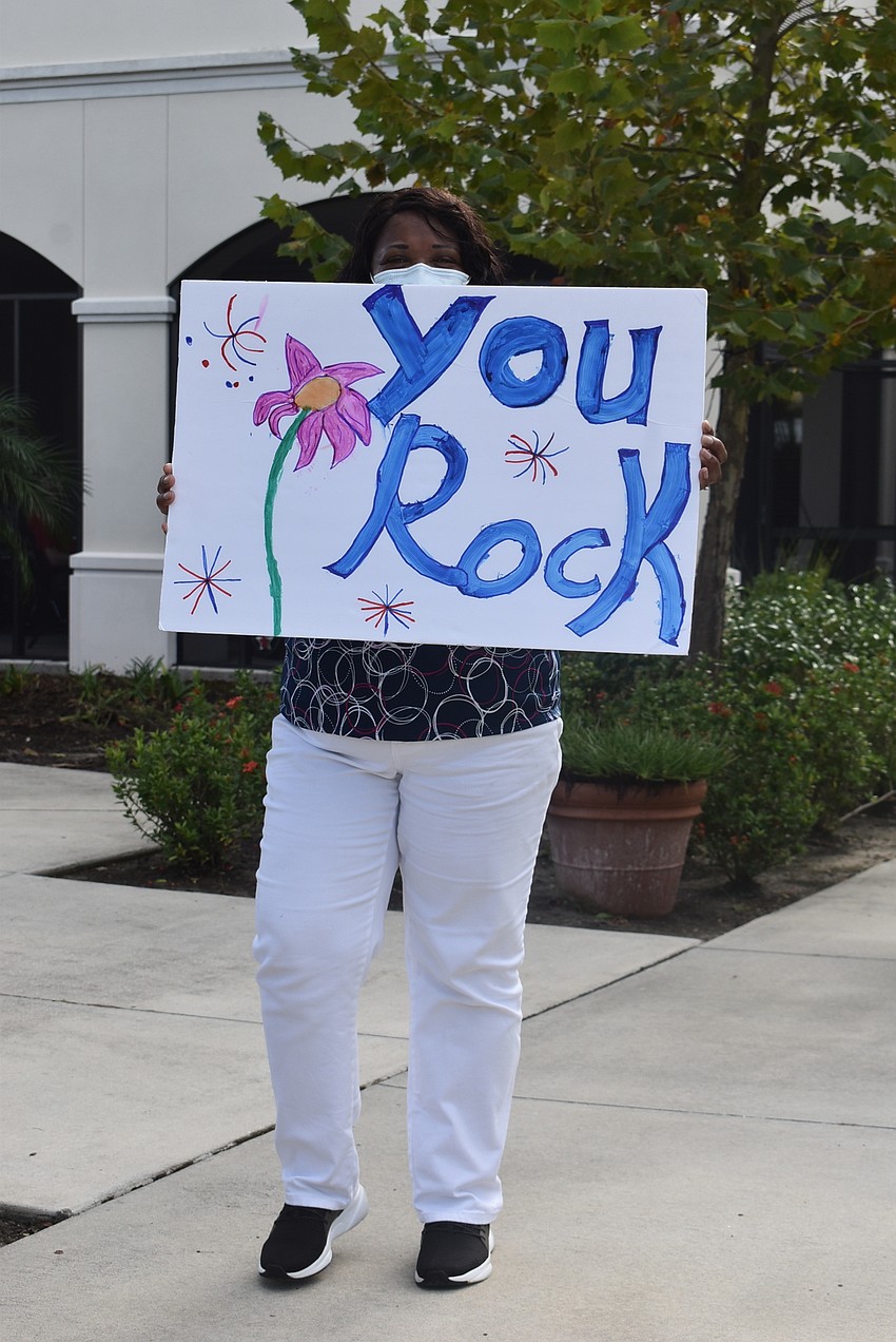 Tidewell Hospice community relations representative Mollie Thomas marches in the parade around The Sheridan at Lakewood Ranch assisted living facility.