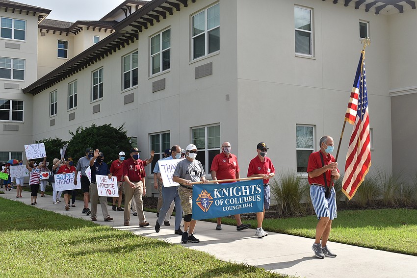 Knights of Columbus member Richard Kuebel (holding American flag) leads the parade around The Sheridan at Lakewood Ranch assisted living facility.